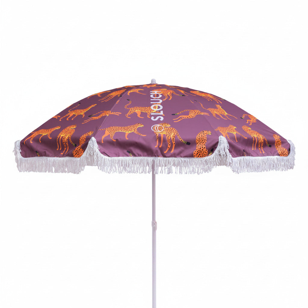 Purple umbrella with orange cheetah pattern on a white background
