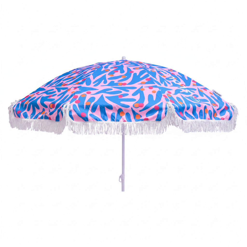 Beach umbrella with a colorful abstract pattern and white fringe on a white background